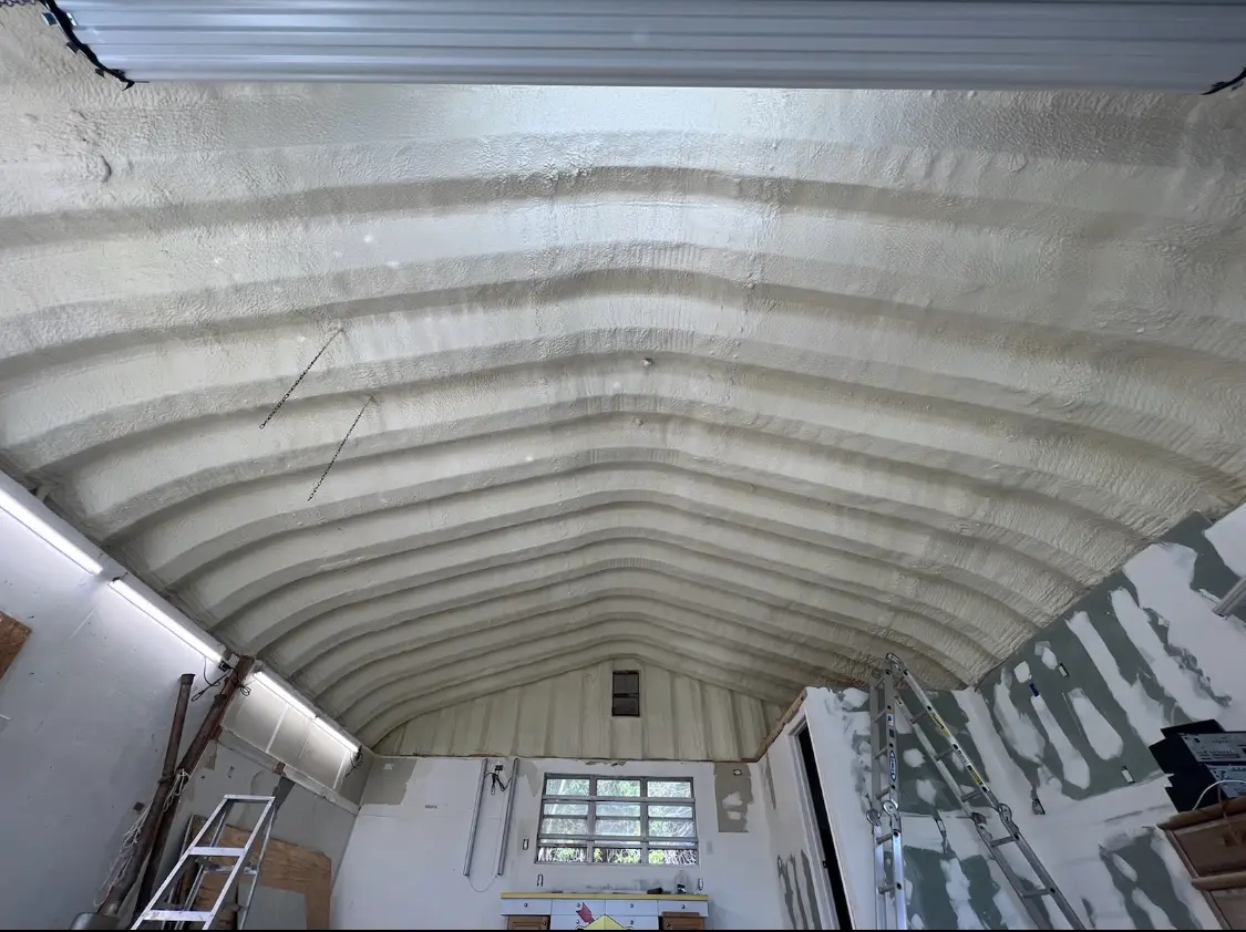 Spray polyurethane foam applied to the underside of a metal roof deck in Satsuma